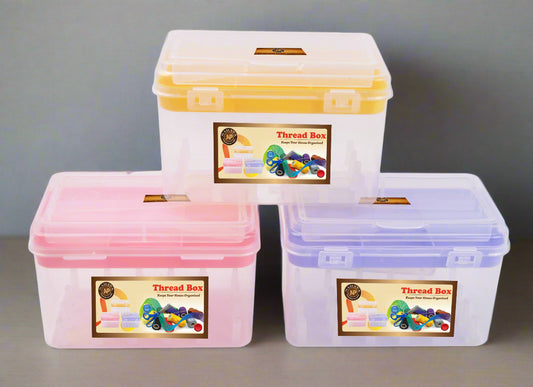 Three colorful thread boxes with labels on a table